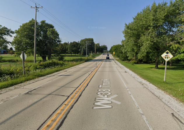 Photo of WIS 38 with cards traveling along roadway.