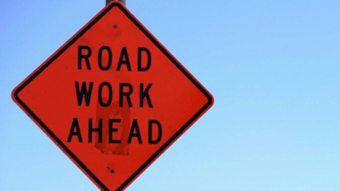 sign saying road work ahead